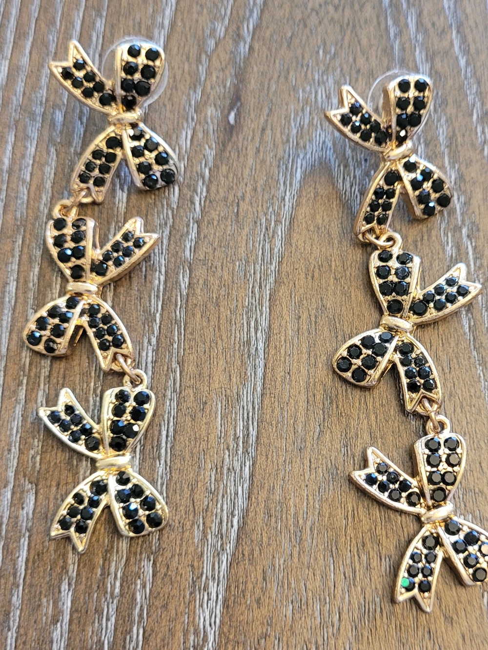 Gold Bow Drop Earrings with Black Stone Details